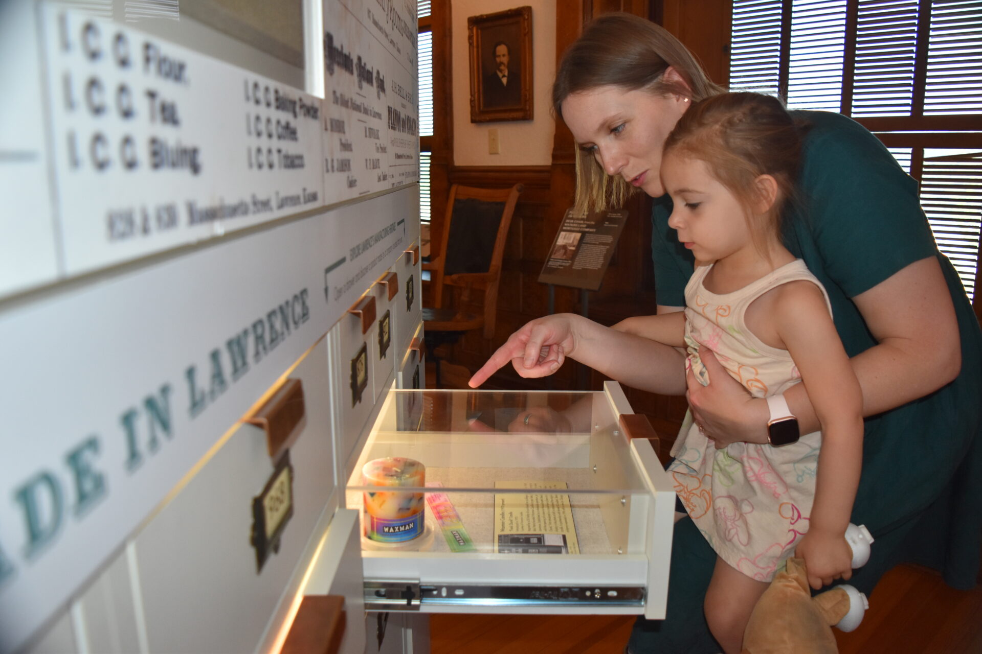 Photograph of a woman and young girl exploring an interactive exhibit.